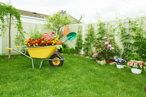 Surbiton arborist performing careful tree maintenance near a home and landscaped garden